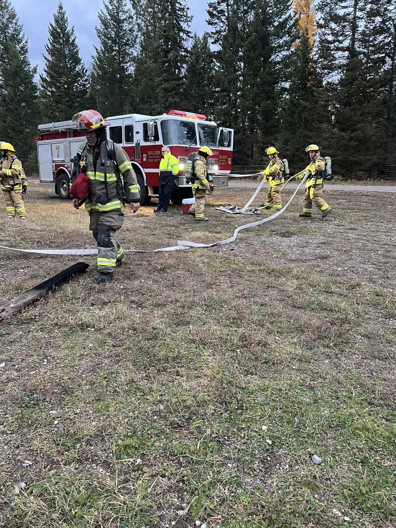 Rollins firefighters working a hose line