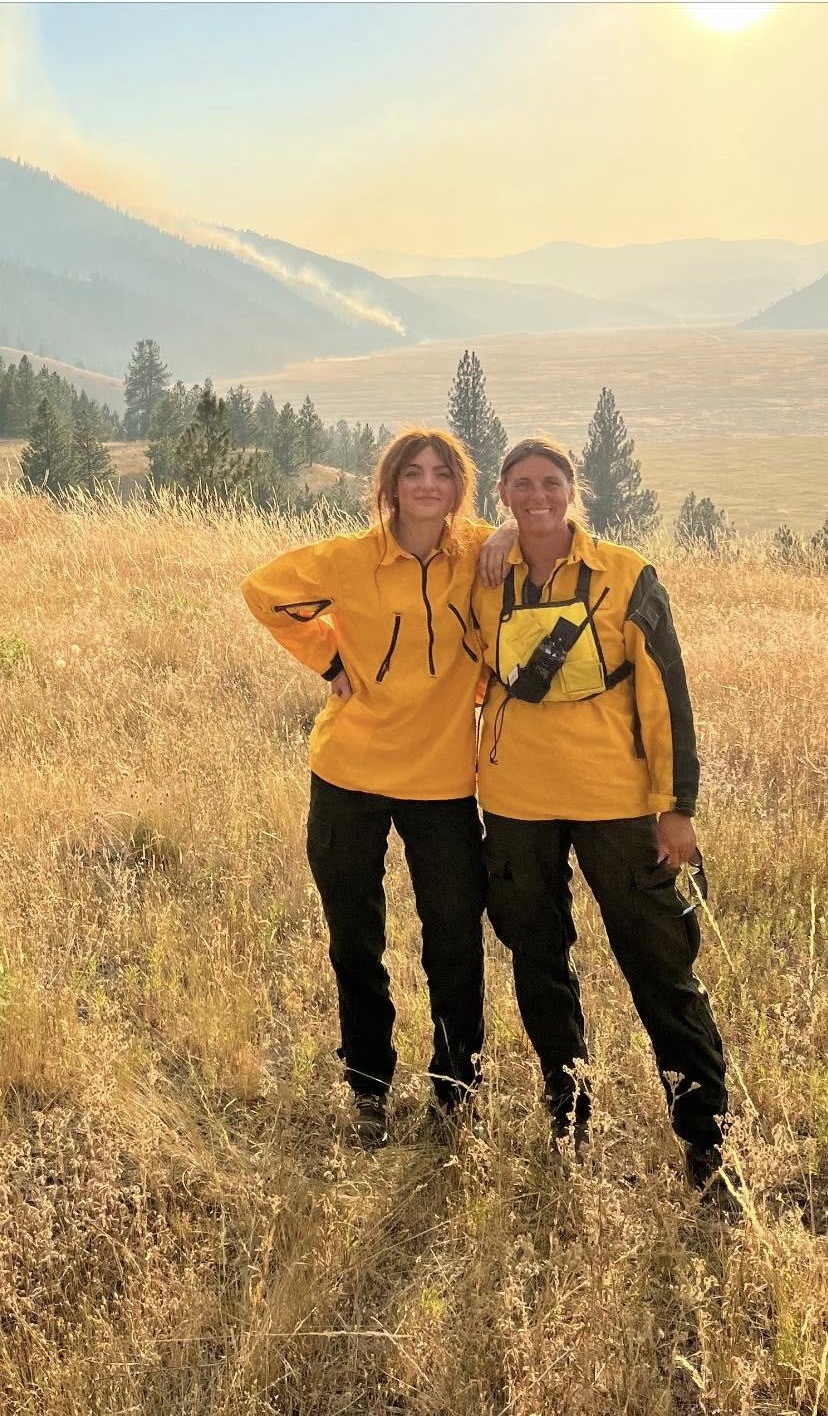Two Rollins volunteers on the fireline at sunset